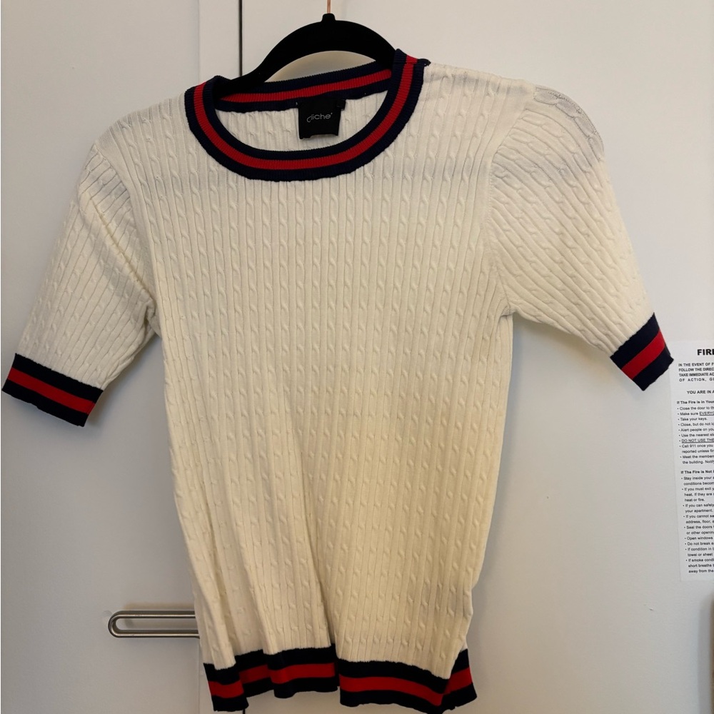 White sweater t shirt with blue and red striped trim